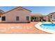 Charming backyard featuring a pool, covered patio, and a mix of desert landscaping for outdoor enjoyment at 9566 E Plana Ave, Mesa, AZ 85212