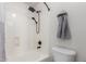 Bathroom with a tub and shower featuring modern fixtures and a white showerhead at 9566 E Plana Ave, Mesa, AZ 85212