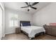 Cozy bedroom with wood floors, a comfortable bed, and ample natural light from the window at 9566 E Plana Ave, Mesa, AZ 85212