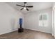 Bedroom with wood floors, natural light, and ceiling fan at 9566 E Plana Ave, Mesa, AZ 85212