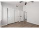 Bedroom featuring wood floors, closet, and a contemporary ceiling fan at 9566 E Plana Ave, Mesa, AZ 85212