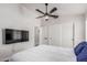 Bedroom featuring wood floors, a comfortable bed, and mounted television at 9566 E Plana Ave, Mesa, AZ 85212