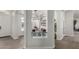 Stylish entryway with glass block detail, gray plank floors, and open view to dining area at 9566 E Plana Ave, Mesa, AZ 85212