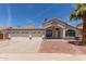 Charming single-story home featuring a three-car garage, desert landscaping, and American flag at 9566 E Plana Ave, Mesa, AZ 85212