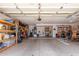 Spacious garage featuring ample storage shelves and a clean, open floor at 9566 E Plana Ave, Mesa, AZ 85212