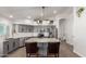 Bright kitchen features gray cabinets, stainless steel appliances, white subway tile, and stone countertops at 9566 E Plana Ave, Mesa, AZ 85212