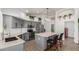 Open kitchen features gray cabinets, stainless steel appliances, stone countertops, and decorative hanging plants at 9566 E Plana Ave, Mesa, AZ 85212