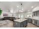 Spacious open concept kitchen and living area features updated appliances, stone countertops, and ample natural light at 9566 E Plana Ave, Mesa, AZ 85212