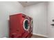 Laundry room with a vibrant red washer and dryer set at 9566 E Plana Ave, Mesa, AZ 85212