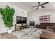 Stylish living room with decorative fireplace, plank floors, and recessed lighting at 9566 E Plana Ave, Mesa, AZ 85212