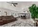 Open concept living room featuring gray cabinets, bar seating, stainless appliances, and modern design at 9566 E Plana Ave, Mesa, AZ 85212