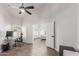 Bright office space with wood floors, open doorway to bedroom, and contemporary desk setup at 9566 E Plana Ave, Mesa, AZ 85212