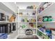 Walk-in pantry offers ample shelving and storage space for food and kitchen essentials at 9566 E Plana Ave, Mesa, AZ 85212