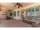 Inviting covered patio features ceiling fans, dining, and a comfortable seating area with stylish wicker furniture at 9566 E Plana Ave, Mesa, AZ 85212