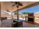 Outdoor patio boasts ample space for relaxation and dining, complete with a built-in grill near the pool at 9566 E Plana Ave, Mesa, AZ 85212
