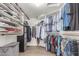 Large walk-in closet with custom shelving and organization for shoes, clothes and accessories at 9566 E Plana Ave, Mesa, AZ 85212