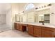 Bathroom featuring dual sinks, large mirror, tiled floor and ample cabinet space at 9802 W Rockwood Dr, Peoria, AZ 85382