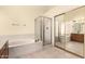 Bathroom featuring a shower, tub, and tile flooring, with mirrored closet doors and plenty of vanity space at 9802 W Rockwood Dr, Peoria, AZ 85382