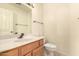 Powder room with a vanity sink, lighting, and white tile at 9802 W Rockwood Dr, Peoria, AZ 85382