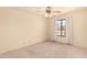 Spacious bedroom featuring plush carpeting, a ceiling fan, and a window offering natural light at 9802 W Rockwood Dr, Peoria, AZ 85382