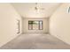 Bright, carpeted bedroom with a ceiling fan and view to backyard at 9802 W Rockwood Dr, Peoria, AZ 85382