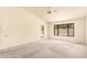 Bedroom with vaulted ceiling, fan, carpet, and view to backyard at 9802 W Rockwood Dr, Peoria, AZ 85382