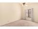 Bedroom with plush carpet, ceiling fan, window, and neutral colored walls providing a bright and airy feel at 9802 W Rockwood Dr, Peoria, AZ 85382