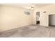Bright bedroom featuring neutral walls, carpet, a ceiling fan, and an arched window for natural light at 9802 W Rockwood Dr, Peoria, AZ 85382