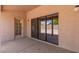 Covered patio with sliding glass doors, extending the living space outdoors at 9802 W Rockwood Dr, Peoria, AZ 85382