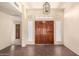 Inviting foyer with tile flooring, a decorative light fixture, and double doors at 9802 W Rockwood Dr, Peoria, AZ 85382