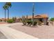 Charming single-story home with desert landscaping, including mature saguaro cacti and gravel groundcover at 9802 W Rockwood Dr, Peoria, AZ 85382