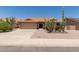 Charming single-story home with desert landscaping, including mature saguaro cacti and gravel groundcover at 9802 W Rockwood Dr, Peoria, AZ 85382