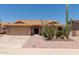 Charming single-story home with desert landscaping, including mature saguaro cacti and gravel groundcover at 9802 W Rockwood Dr, Peoria, AZ 85382