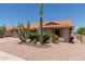 Charming single-story home with desert landscaping, including mature saguaro cacti and gravel groundcover at 9802 W Rockwood Dr, Peoria, AZ 85382