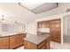 View of the kitchen with an island and view into the Gathering room at 9802 W Rockwood Dr, Peoria, AZ 85382
