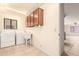 Bright laundry room features a utility sink, washer, dryer, and cabinet storage at 9802 W Rockwood Dr, Peoria, AZ 85382