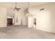 Spacious living room with a ceiling fan and an elegant chandelier at 9802 W Rockwood Dr, Peoria, AZ 85382