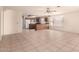 Open-concept living room with tiled floor next to kitchen at 9802 W Rockwood Dr, Peoria, AZ 85382
