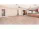 Bright and airy living room with tile flooring and access to the kitchen at 9802 W Rockwood Dr, Peoria, AZ 85382