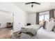 This bedroom features a ceiling fan and a view into the living area from the bedroom at 10080 E Mountainview Lake Dr # 327, Scottsdale, AZ 85258