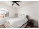 Inviting bedroom with a neutral palette, complemented by a ceiling fan and charming window at 10080 E Mountainview Lake Dr # 327, Scottsdale, AZ 85258