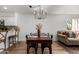 Dining area with a dark wooden table and chairs, featuring an elegant chandelier and comfortable seating at 10080 E Mountainview Lake Dr # 327, Scottsdale, AZ 85258