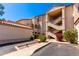 Condominium complex featuring a red tile roof, multiple staircases, and desert landscaping at 10080 E Mountainview Lake Dr # 327, Scottsdale, AZ 85258