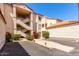 Condominium complex exterior with multiple staircases, beautiful desert landscaping, and red tile roof at 10080 E Mountainview Lake Dr # 327, Scottsdale, AZ 85258