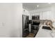 Modern kitchen with stainless steel appliances, white cabinets, and a sink with gold faucet at 10080 E Mountainview Lake Dr # 327, Scottsdale, AZ 85258