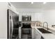 Contemporary kitchen featuring stainless steel appliances, white cabinets, and marble countertops at 10080 E Mountainview Lake Dr # 327, Scottsdale, AZ 85258