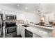Bright kitchen featuring white cabinets, stainless steel appliances, and a marble countertop bar at 10080 E Mountainview Lake Dr # 327, Scottsdale, AZ 85258
