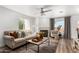 Inviting living room featuring a fireplace, ceiling fan, and cozy seating area at 10080 E Mountainview Lake Dr # 327, Scottsdale, AZ 85258