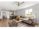 Open-concept living space with a comfortable sofa and stylish dining area with modern chandelier at 10080 E Mountainview Lake Dr # 327, Scottsdale, AZ 85258