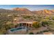 Stunning aerial view of a desert estate with a pool, spa, and breathtaking mountain backdrop at 11986 N 134Th Pl, Scottsdale, AZ 85259